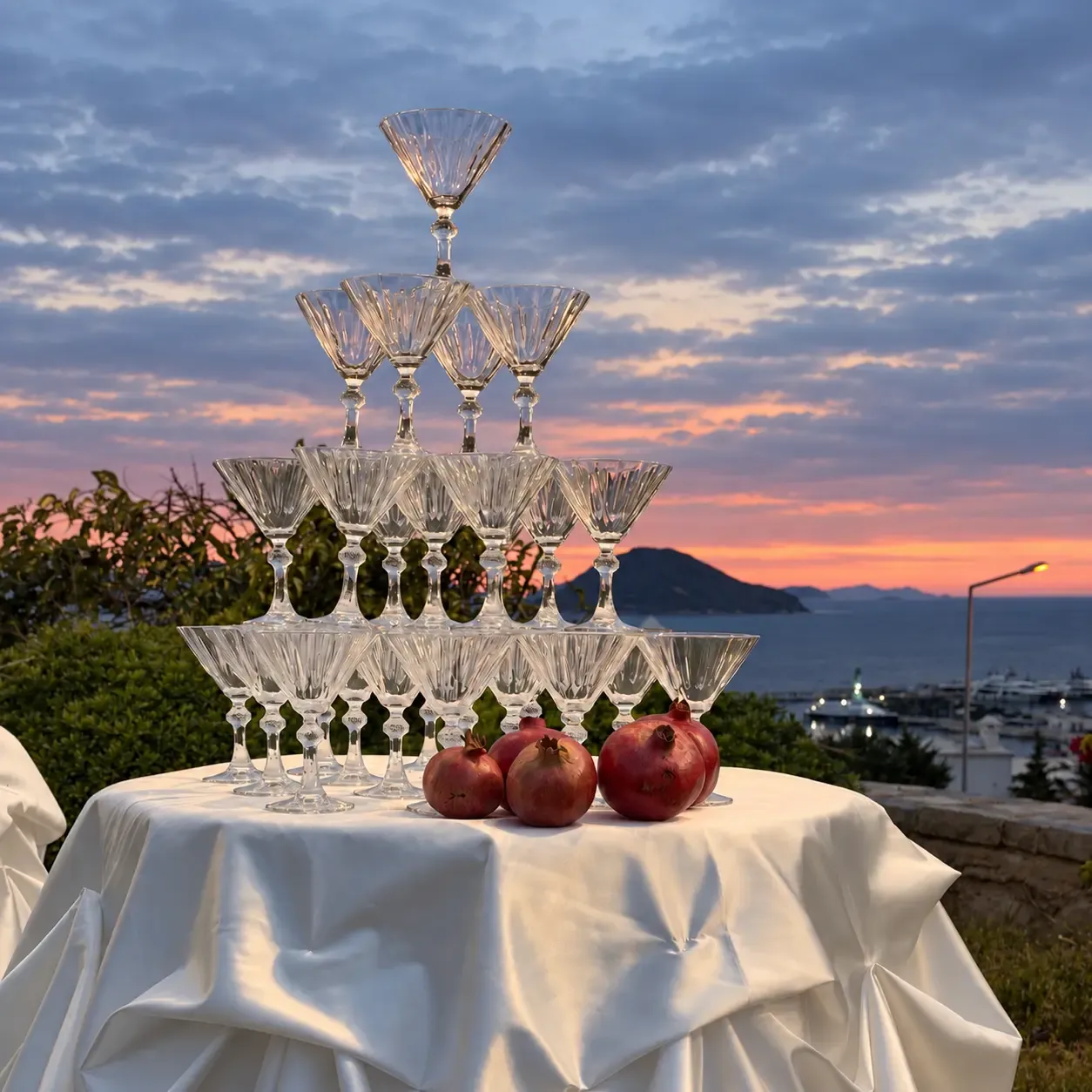 Champagne tower with pomegranates at a sunset wedding reception, Bodrum
